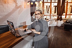 Receptionist standing at reception counter in office