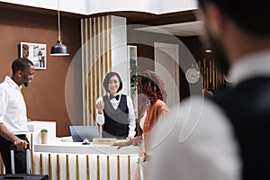Receptionist talking to hotel guests