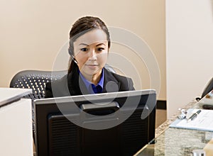 Receptionist with telephone earpiece