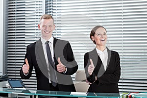 Receptionists showing thumbs up sign