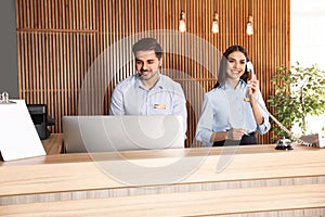 Receptionists working at desk in lobby photo