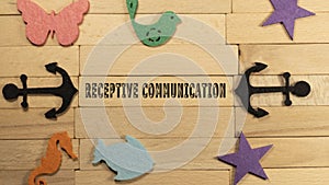 Receptive communication written on a wood-patterned surface. Education and child psychology