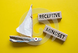 Receptive Mindset symbol. Concept word Receptive Mindset on wooden blocks. Beautiful yellow background with boat. Business and