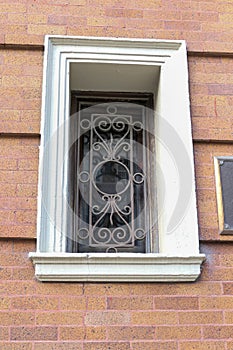 A recessed window with a decorative metal grill