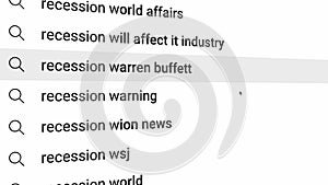 Recession is being typed in a search bar on a computer LCD monitor screen.