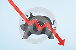 Recession concept with red arrow hitting black piggy bank at blue background