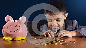 Recession and negative returns. Sad kid in a suit counting money near an empty piggy bank