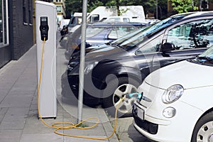 Recharge. Electric Car in Free Charging Station. Environmentally Friendly Transport