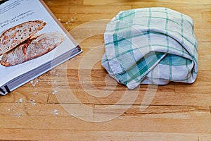 Reciep book and fermenting dough in towel photo