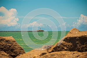 RECIFE, PERNAMBUCO, BRAZIL: Lighthouse on the horizon. Beautiful landscape with views of the rocks and turquoise sea