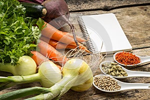 Recipe background. Fresh vegetables with blank page of cookbook