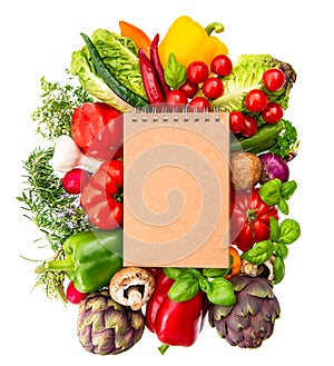 recipe book with fresh vegetables and herbs. healthy food ingredients