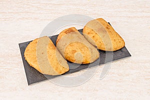 Recipe for Chilean empanadas stuffed with meat on a black slate plate