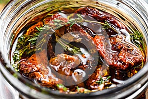 Recipe for cooking dried tomatoes in olive oil with spices and herbs. Gray background. Top view