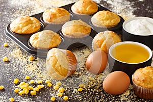 Recipe for corn muffins in a baking dish and ingredients close-up. horizontal