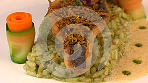 Recipe for fried fillet of sea bass with herb risotto, white wine sauce, fresh creme, roll of carrot and courgette