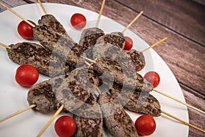 Recipe of kefta, beef skewer, Traditional homemade, with small tomatoes, Arabic and Libanese food