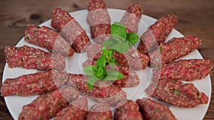 RECIPE FOR LEBANESE KEBBE NAYYHE, RAW MINCED BEEF, MARJORAM, MINT, ONIONS, CRUSHED WHEAT, SEVEN SPICES, CINNAMON
