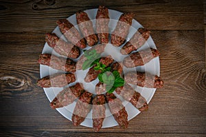 RECIPE FOR LEBANESE KEBBE NAYYHE, RAW MINCED BEEF, MARJORAM, MINT, ONIONS, CRUSHED WHEAT, SEVEN SPICES, CINNAMON