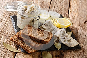 Recipe for marinated herring with onions, vinegar, spices in oil in a bank close-up. horizontal