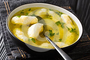 Recipe for Soup with Semolina Dumplings close-up in a plate. horizontal