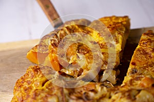 Spanish omelette with roasted sweet potatoes. Traditional tapa recipe with egg, potato and onion. photo