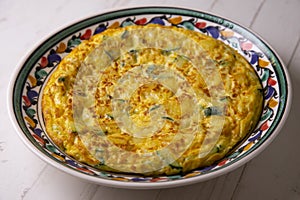 Spanish potato omelette with zucchini and young garlic. Traditional tapa recipe with egg, potato and onion. photo