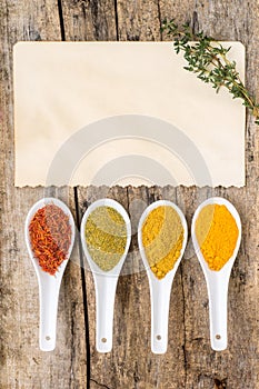 Recipe spice background. Various spicy mix with old paper sheet with thyme