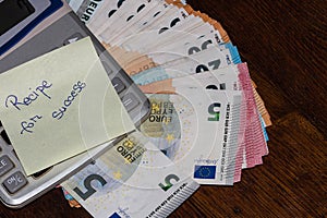 Recipe for success, calculator and euro money on table