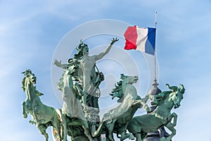 Recipon Quadrigas statues and France flag at the top of Grand Palais