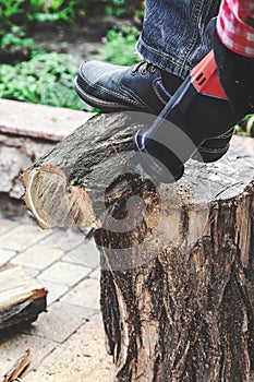 Reciprocating power saw sawing round timber closeup