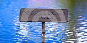 Recirculated water sign on shiny blue water