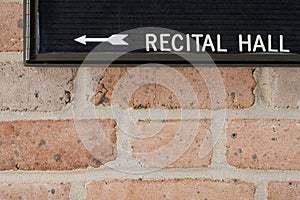 Recital hall sign on brick wall photo