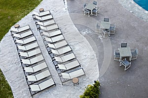 Recliners and tables at beachside resort