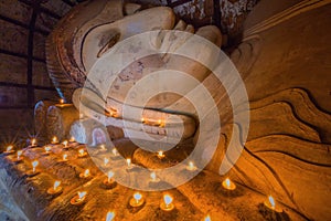 Reclining Buddha with candle light at Shwesandaw temple