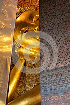 Reclining Buddha gold statue face. Wat Pho