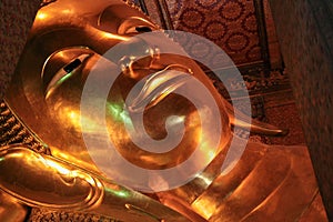 Reclining Buddha gold statue face in Wat Pho, Bangkok