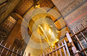 the Reclining Buddha gold statue face. Wat Pho, Bangkok, Thailand