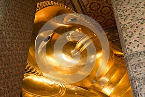 Reclining Buddha gold statue face. Wat Pho, Bangkok, Thailand