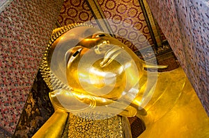 Reclining Buddha gold statue face. Wat Pho, Bangkok, Thailand