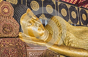 Reclining Buddha gold statue in temple of Thailand.