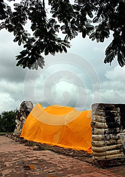 Reclining Buddha statue covered with an orange canvas, Thailand