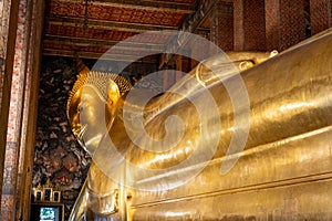 Reclining Buddha statue in Wat Pho, a famous Buddhist temple complex in Bangkok, Thailand