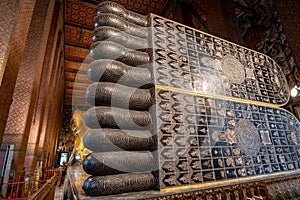 Reclining Buddha statue in Wat Pho, a famous Buddhist temple complex in Bangkok, Thailand