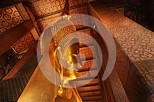 Reclining Gold Buddha statue with close up on the face. Wat Pho, Bangkok, Thailand, Asia