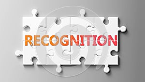 Recognition complex like a puzzle - pictured as word Recognition on a puzzle pieces to show that Recognition can be difficult and