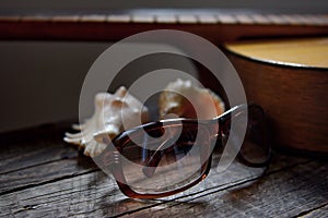 Recollection of summer, guitar, sunglasses and shells from the sea photo