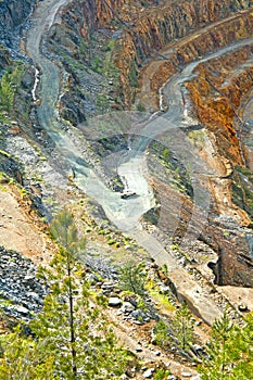 reconnaissance car descending into an open pit mine