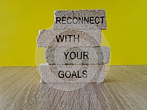 Reconnect with your Goals symbol. Brick blocks with words Reconnect with your goals.