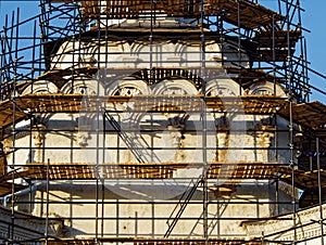 Reconstructed building with decorative elements in scaffolding
